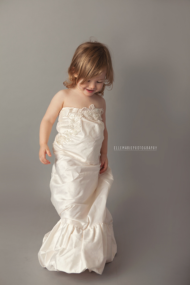Child wearing mommy's wedding dress