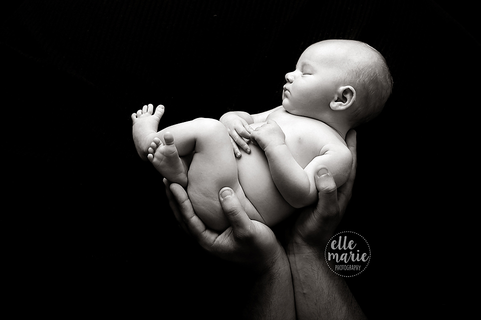 newborn in dad's hands