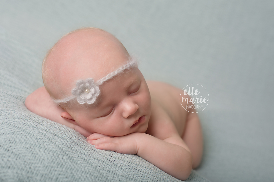 newborn with head on hands