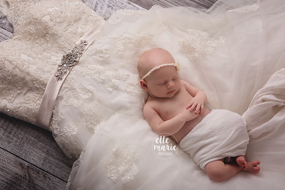 newborn on mom's wedding dress