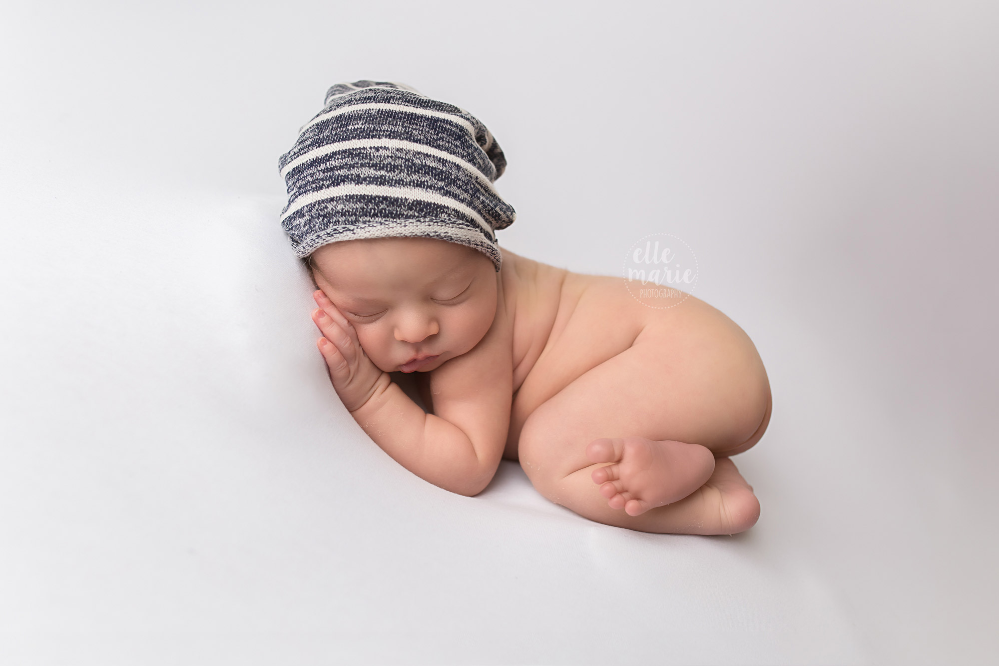 Baby in little hat taking a nap