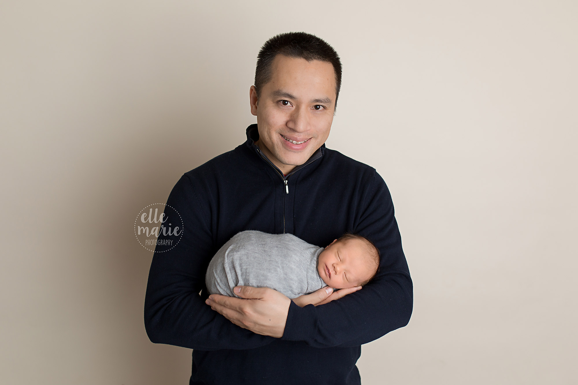 dad holding newborn son