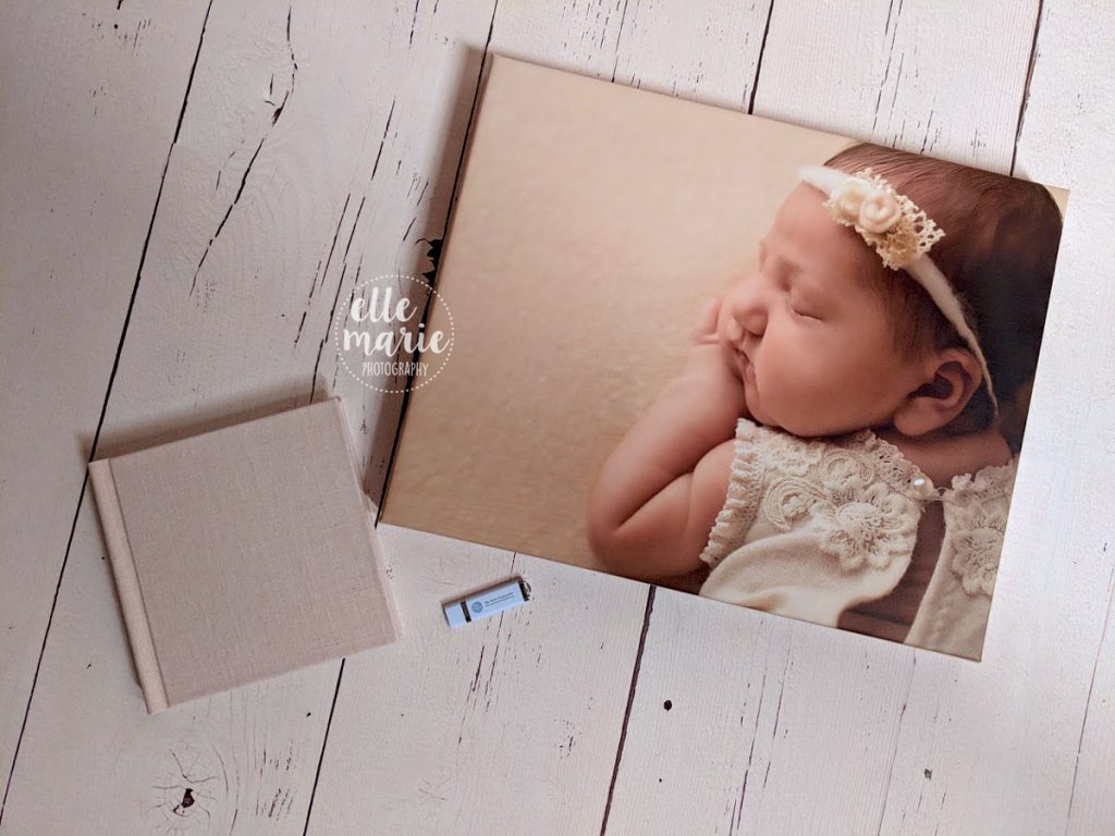 canvas, album and usb laying flat on wood