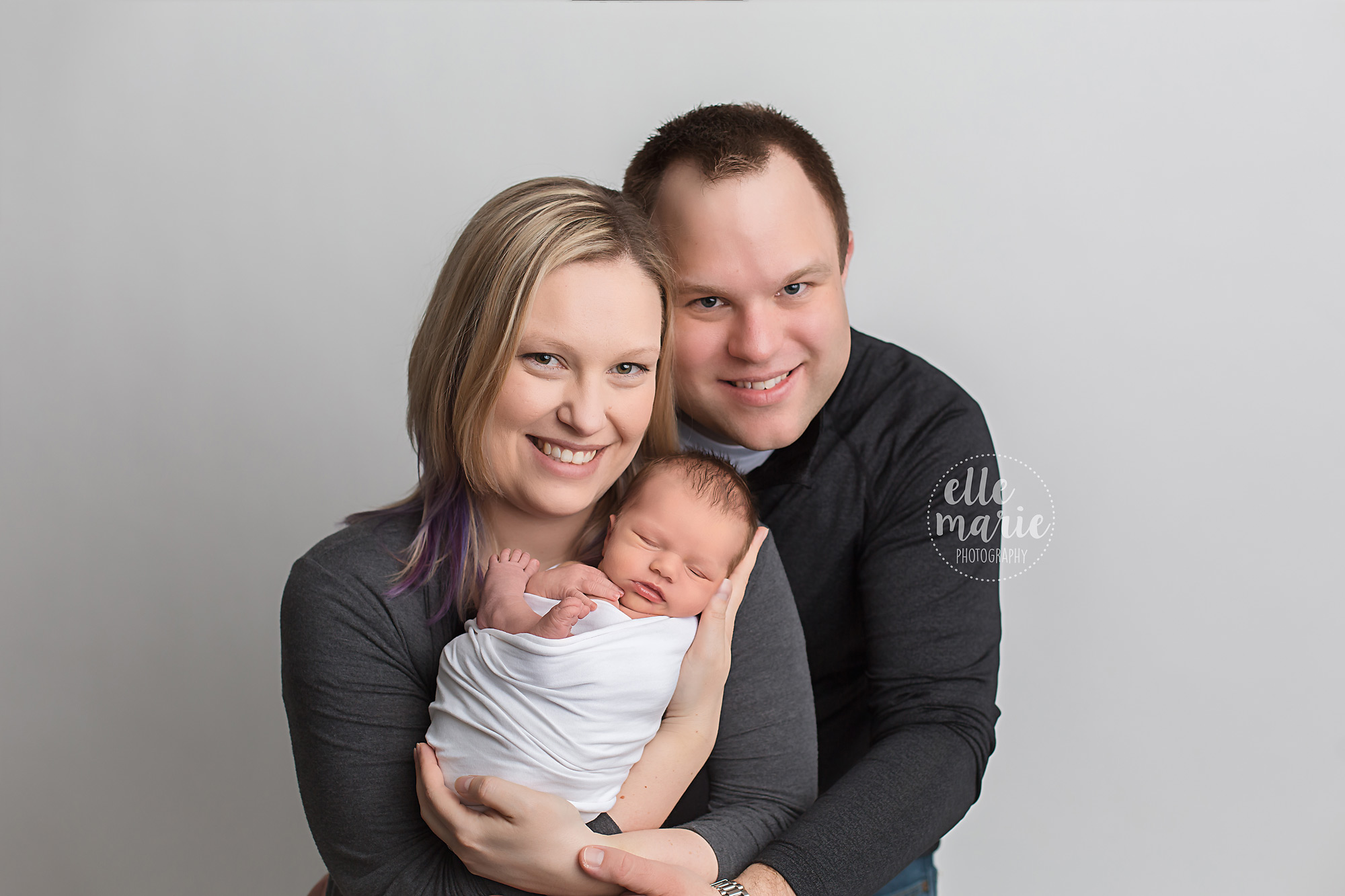 new parents holding baby girl