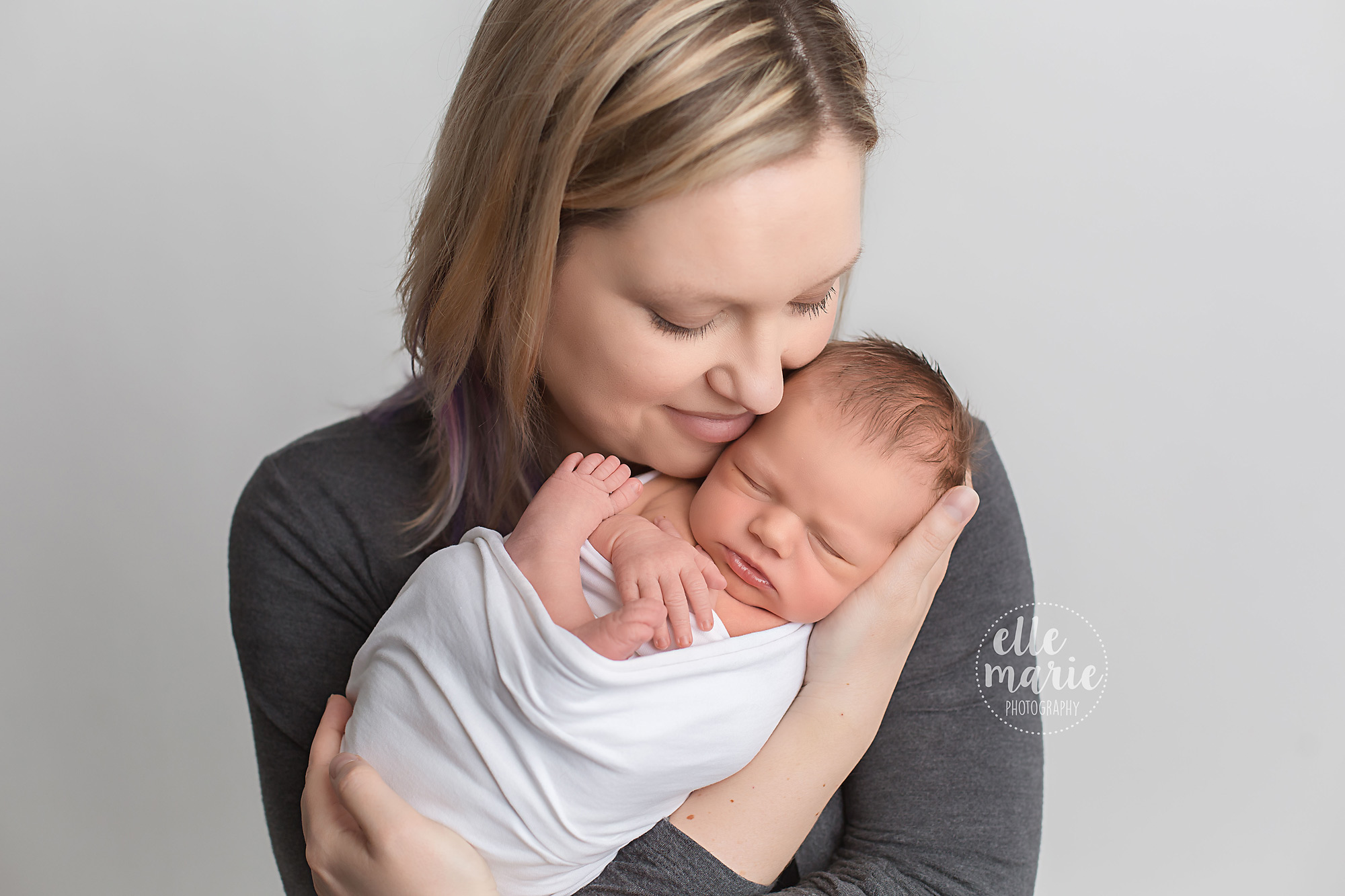 new mom holds baby daughter