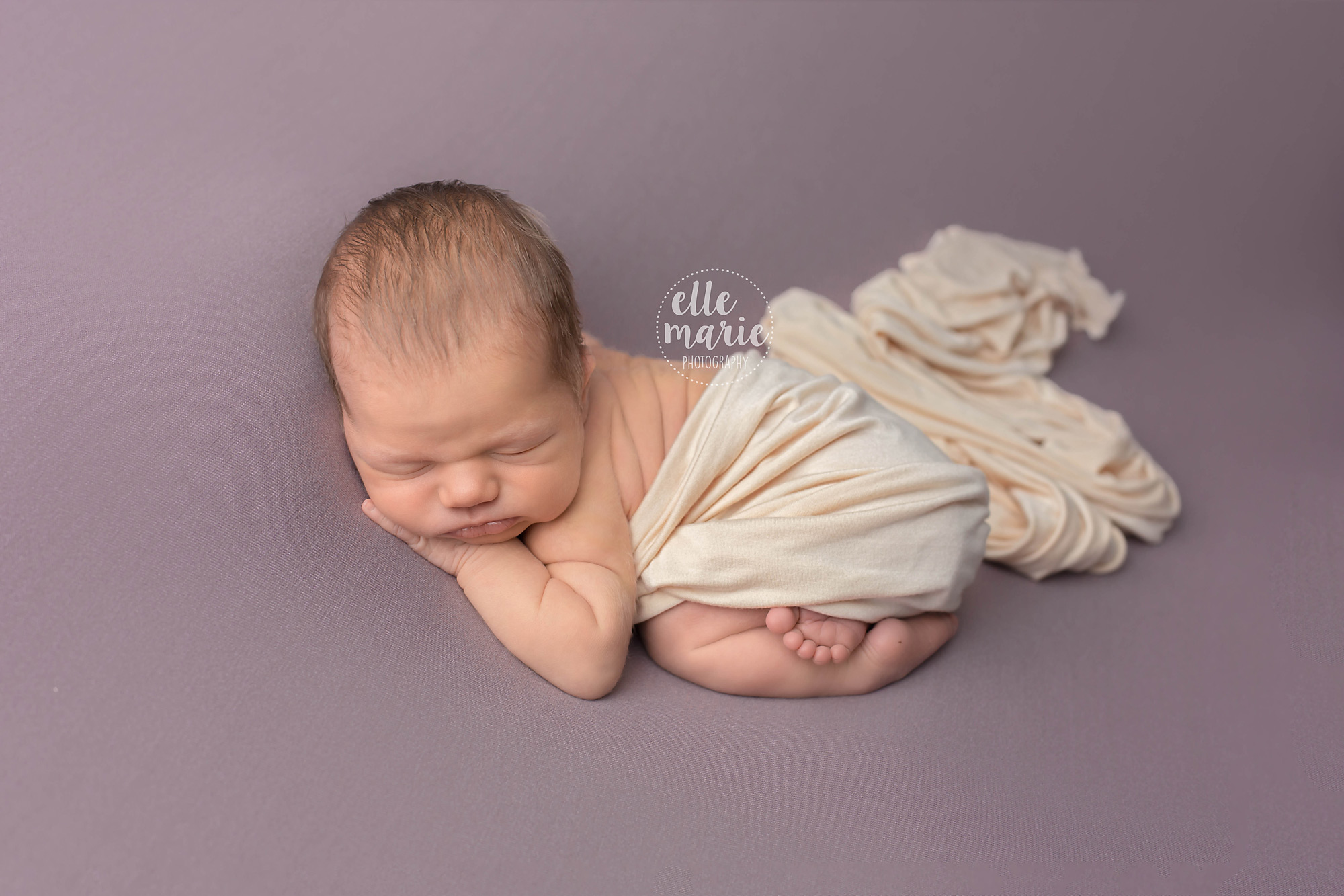 newborn girl in bum up pose on purple blanket