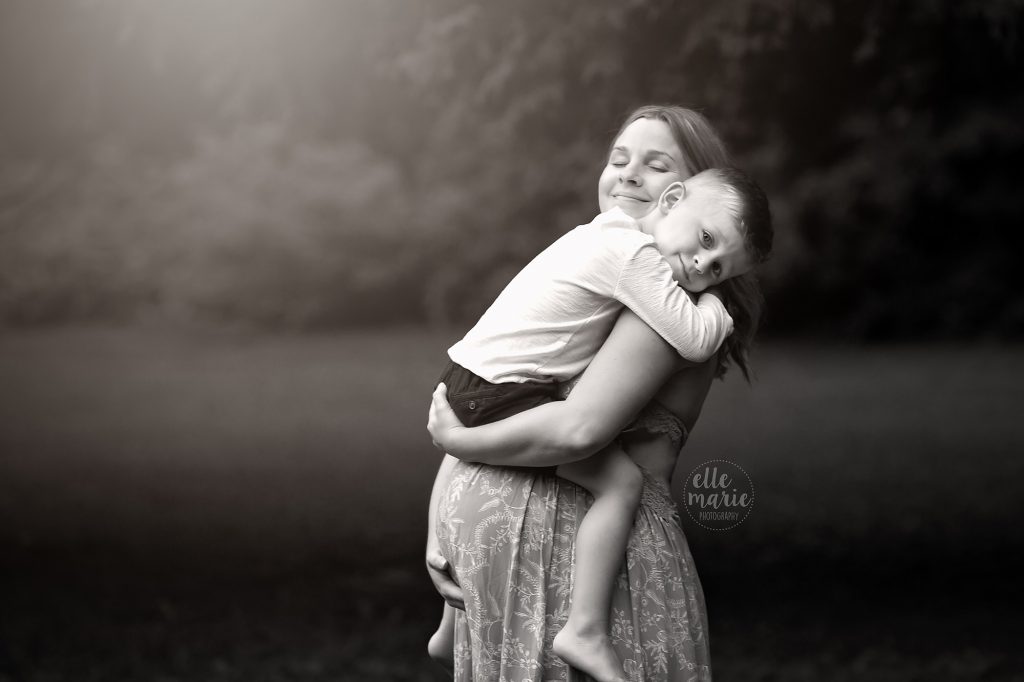 pregnant mom hugs toddler son