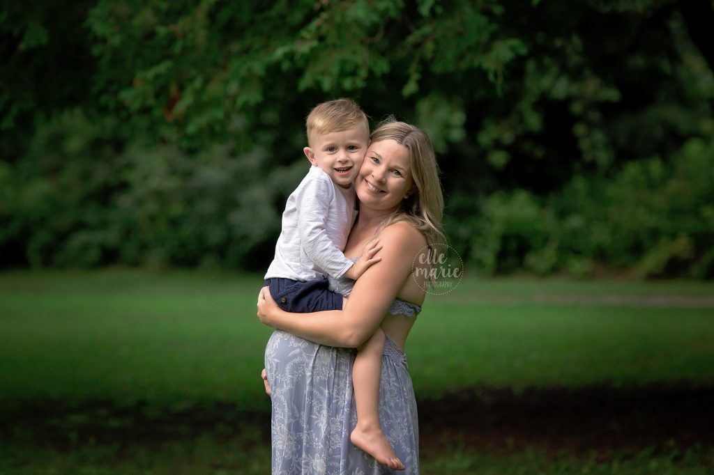 pregnant mom hugs toddler son