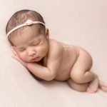 newborn baby girl laying on her side