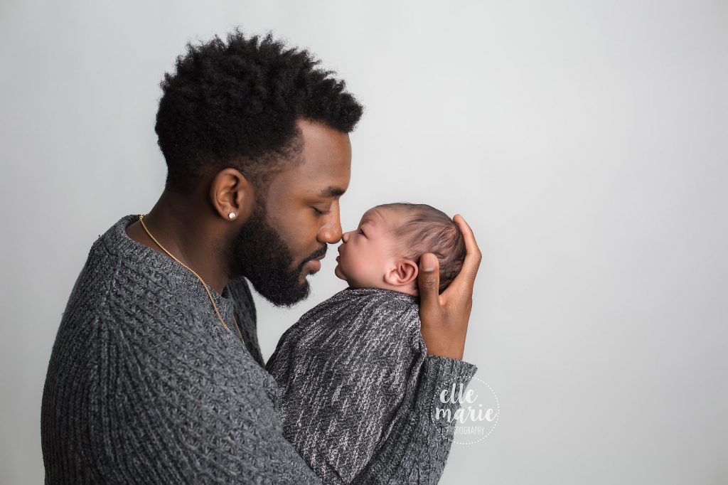 newborn baby boy in dad's arms