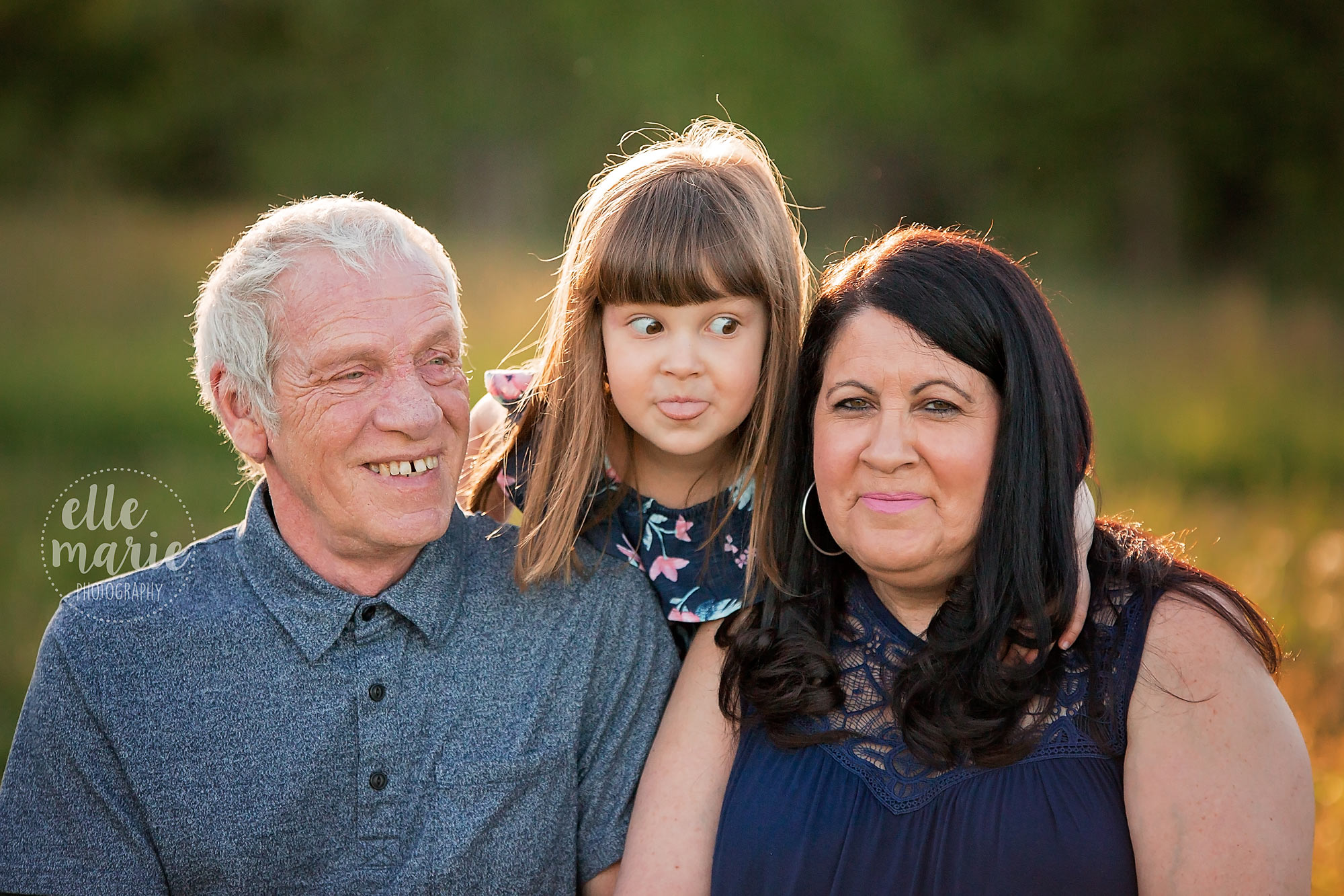 young girl making a silly face with her grandparents