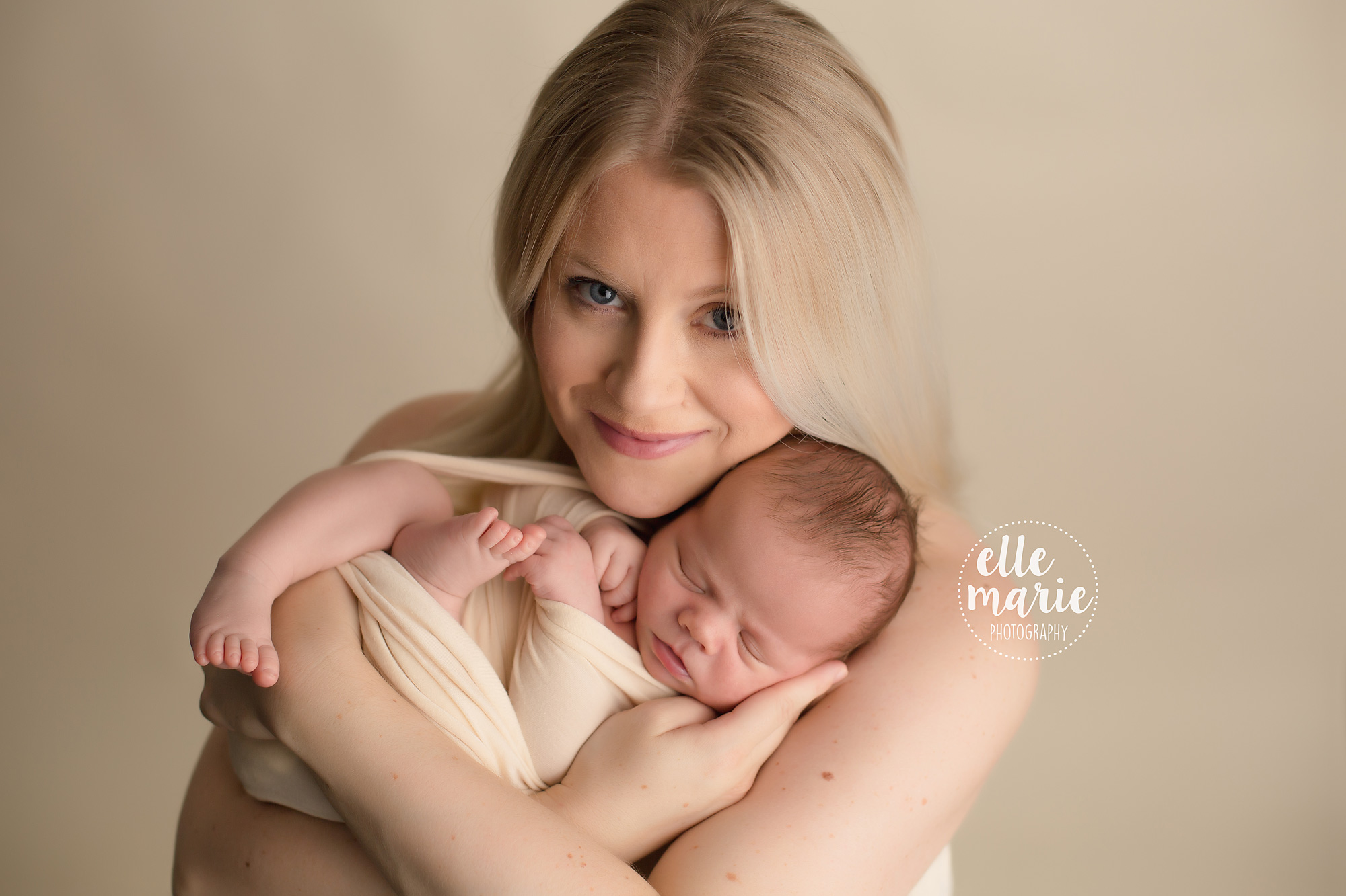 New mom cradles her newborn son in her arms