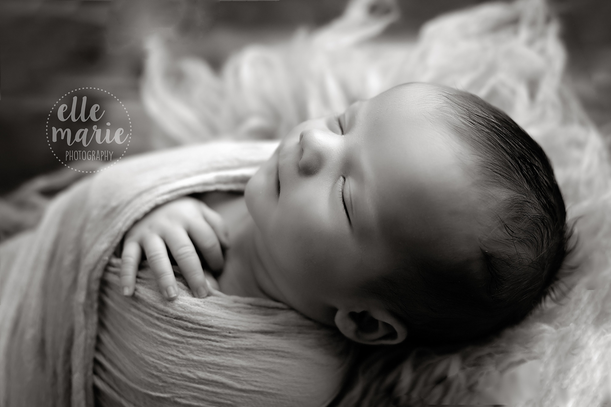 side profile shot of newborn baby boy in black and white