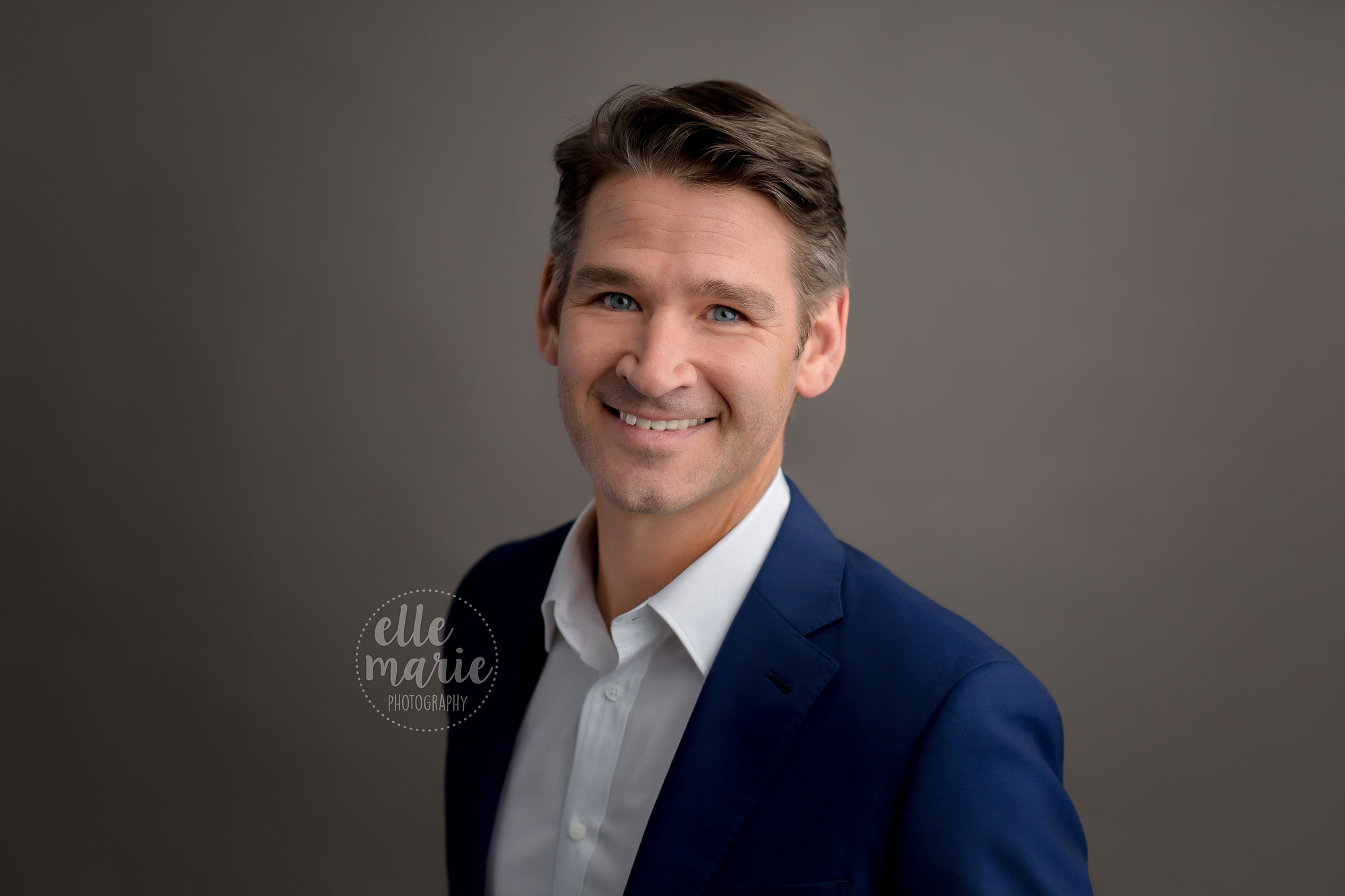 standard business headshot of a man with a slightly relaxed feel