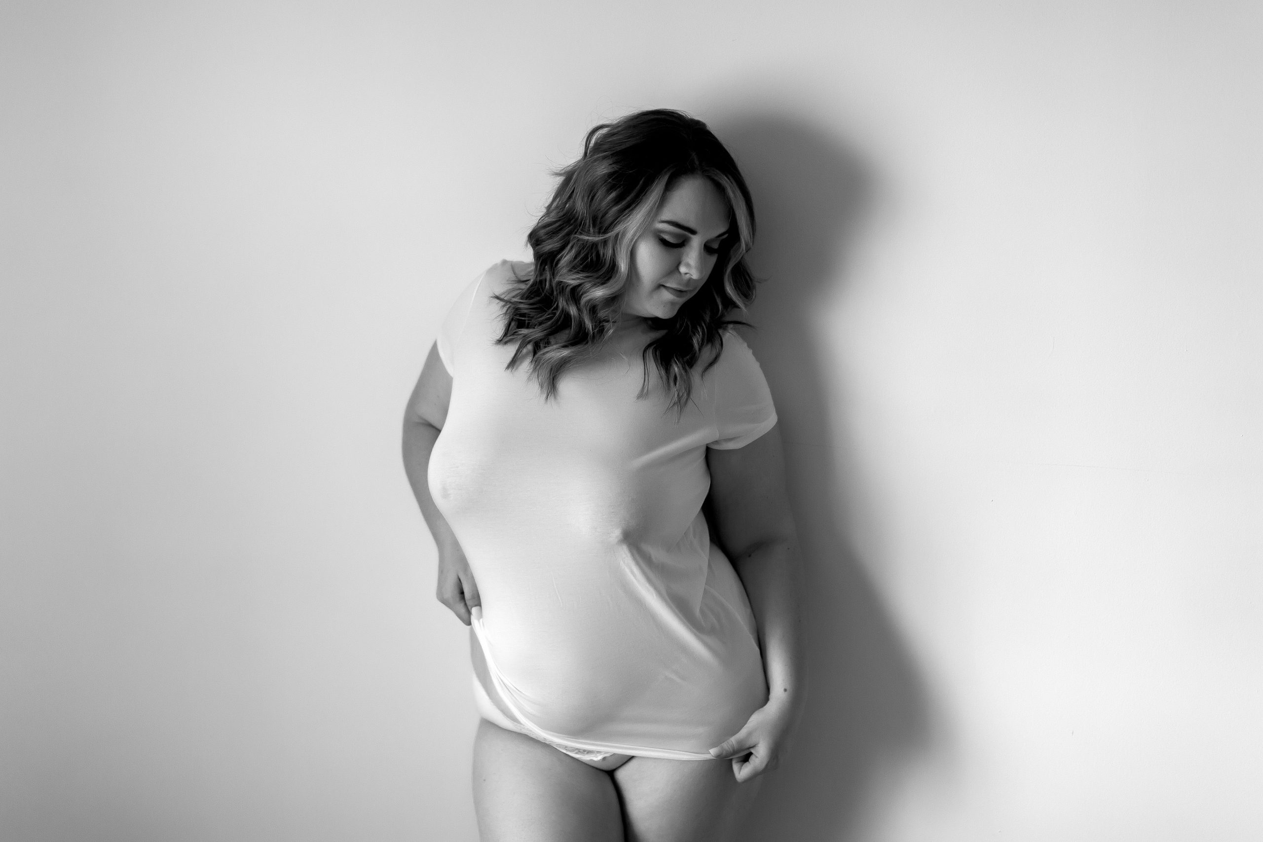 Black and White image of woman in a plain white tshirt, boudoir style