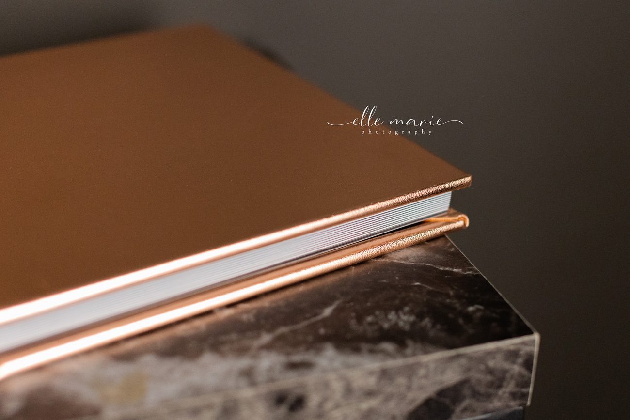 close up of gold cover boudoir album sitting closed on a table