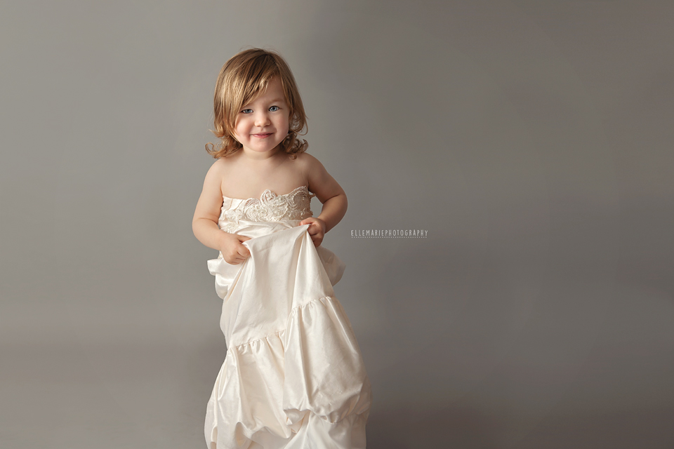 toddler wearing mommy's wedding dress