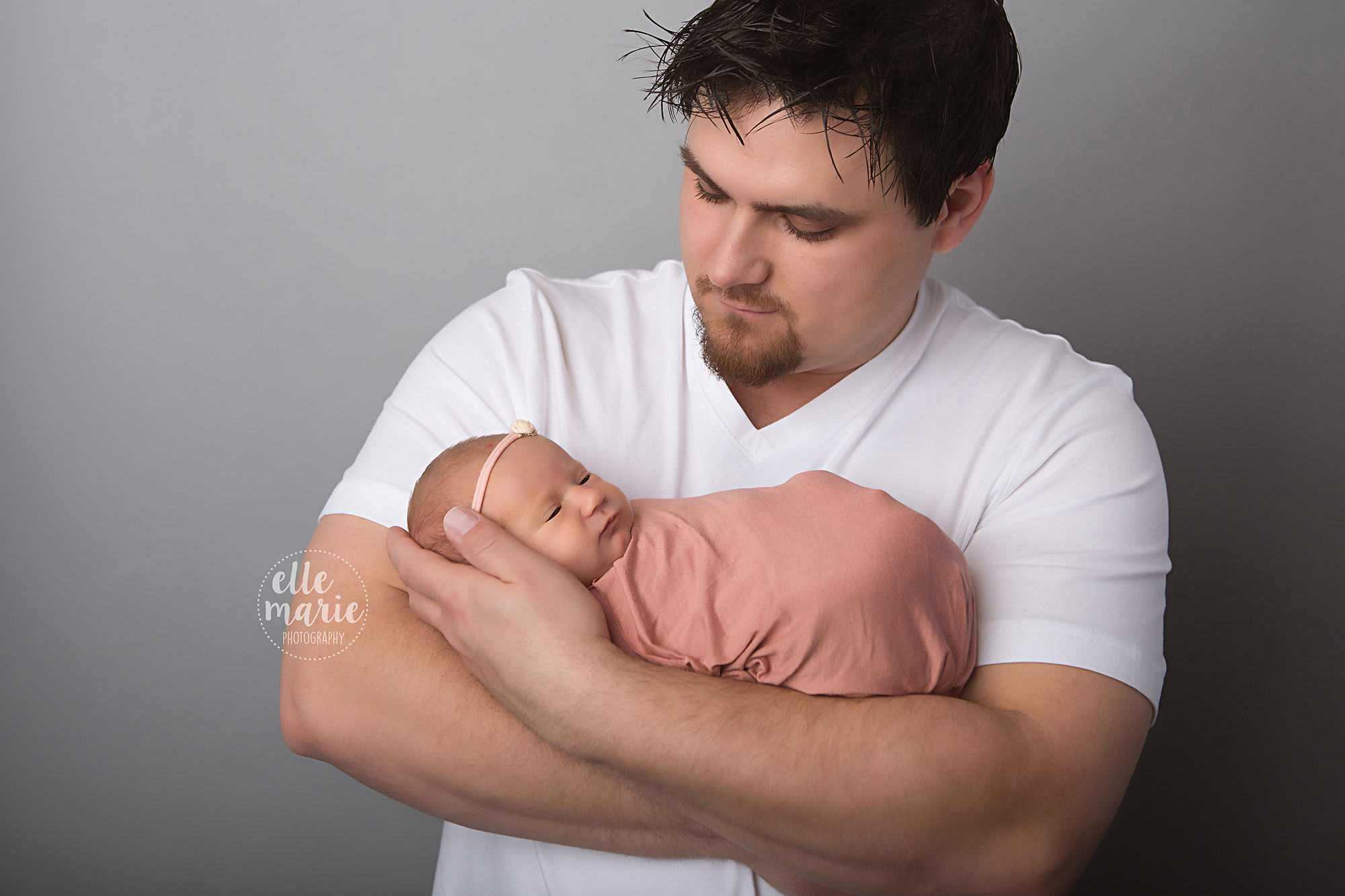 newborn girl in daddy's arms
