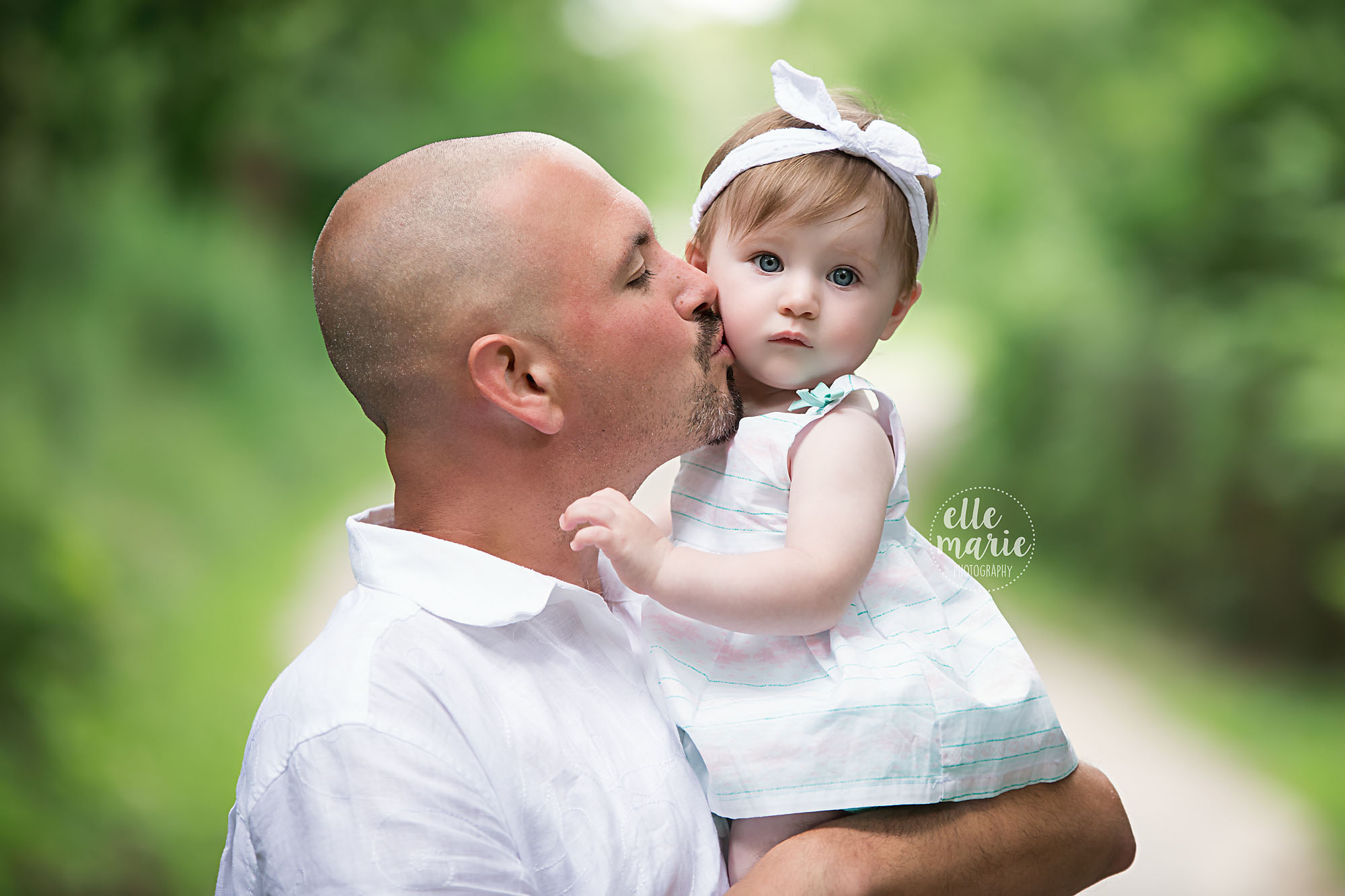 dad kissing baby daughter