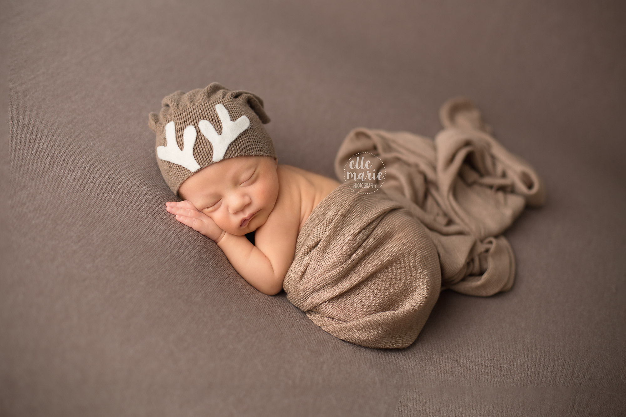 newborn baby boy with reindeer hat for Christmas