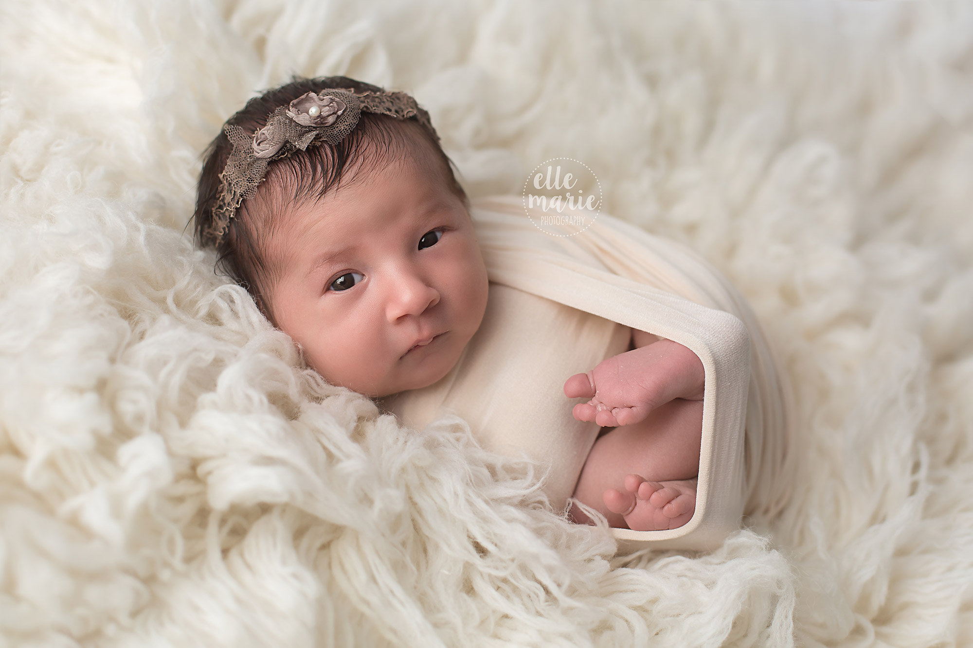 newborn wrapped in cream wrap in whitby studio