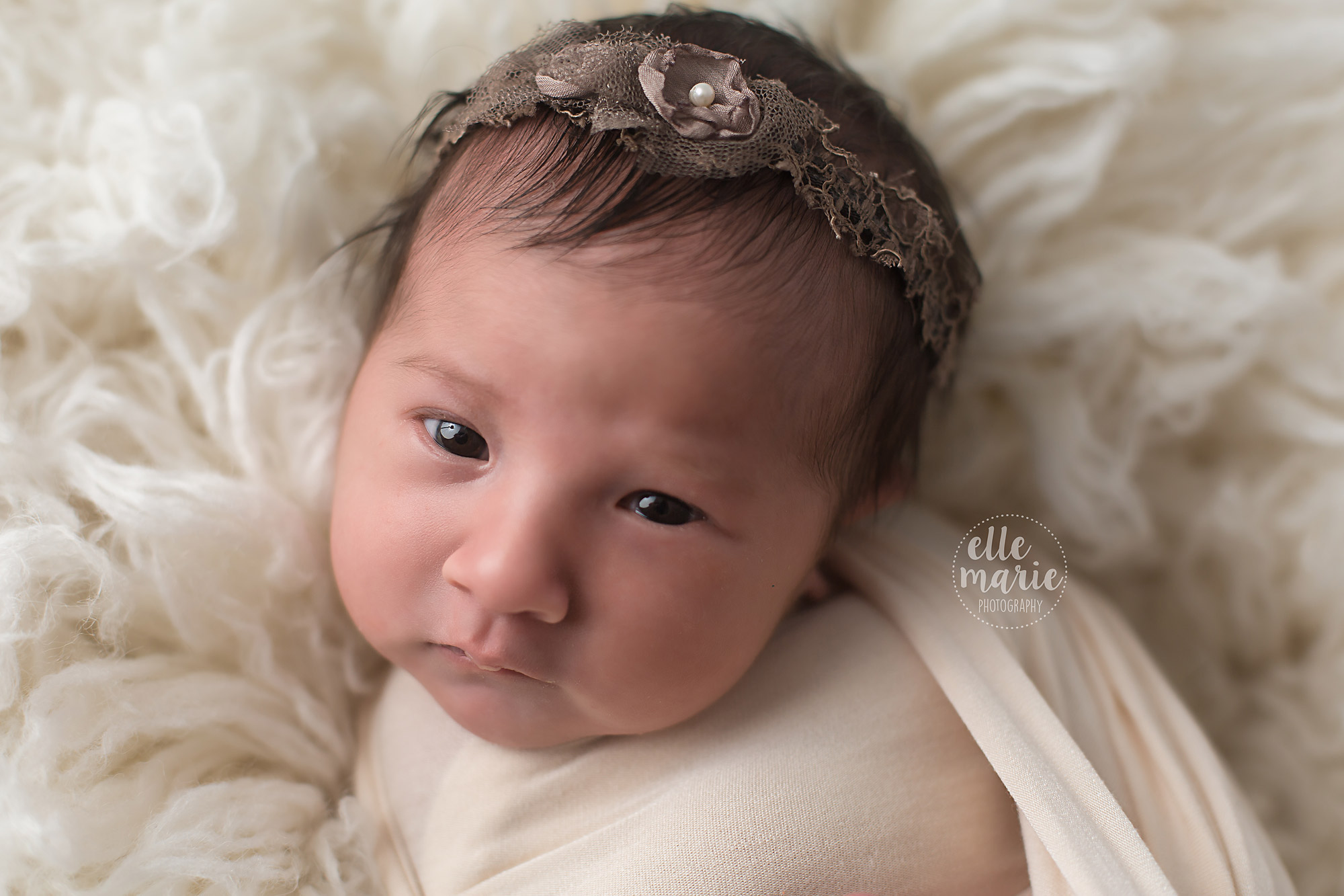 face of newborn with brown head tie