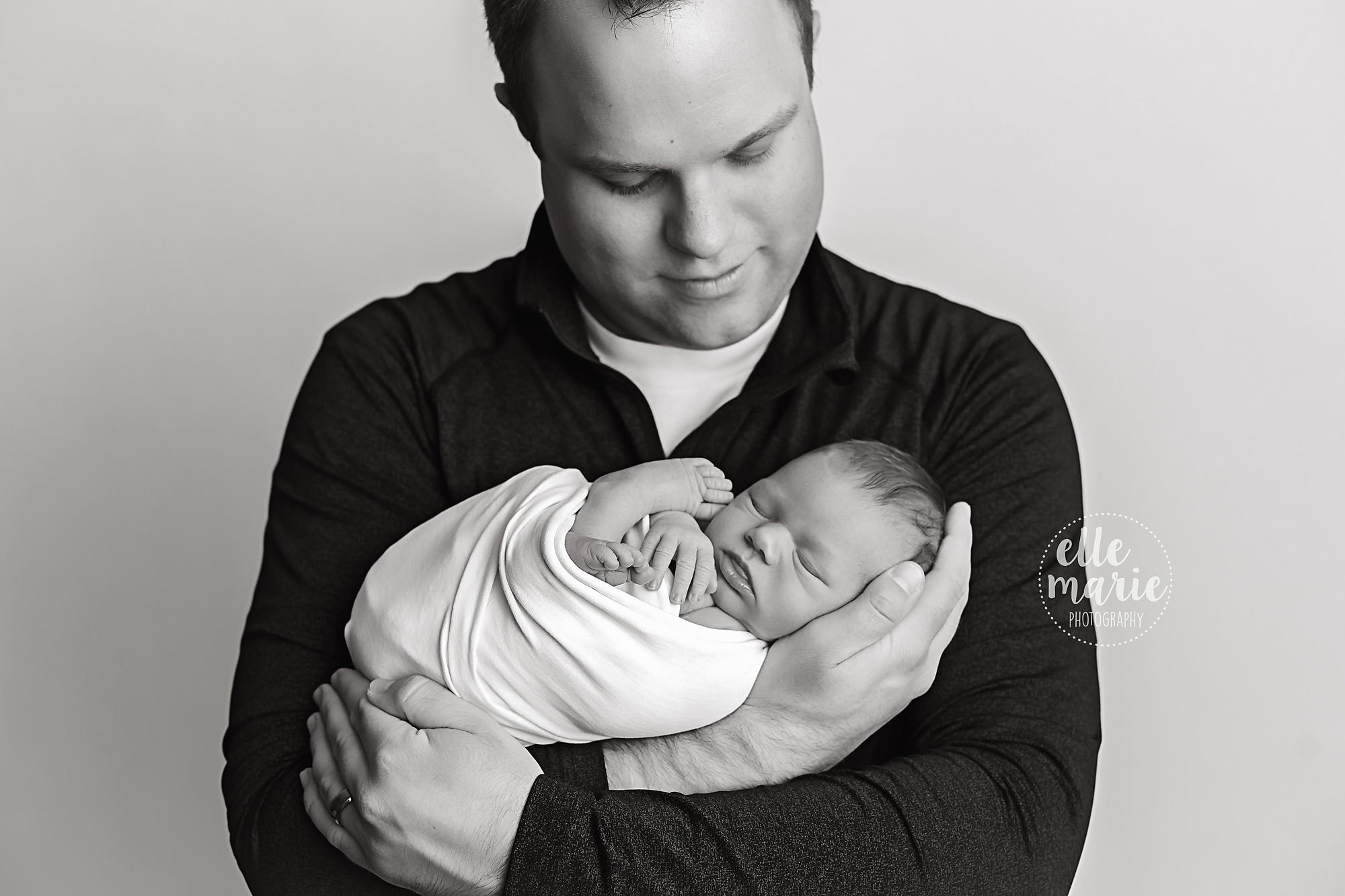 newborn in dad's arms