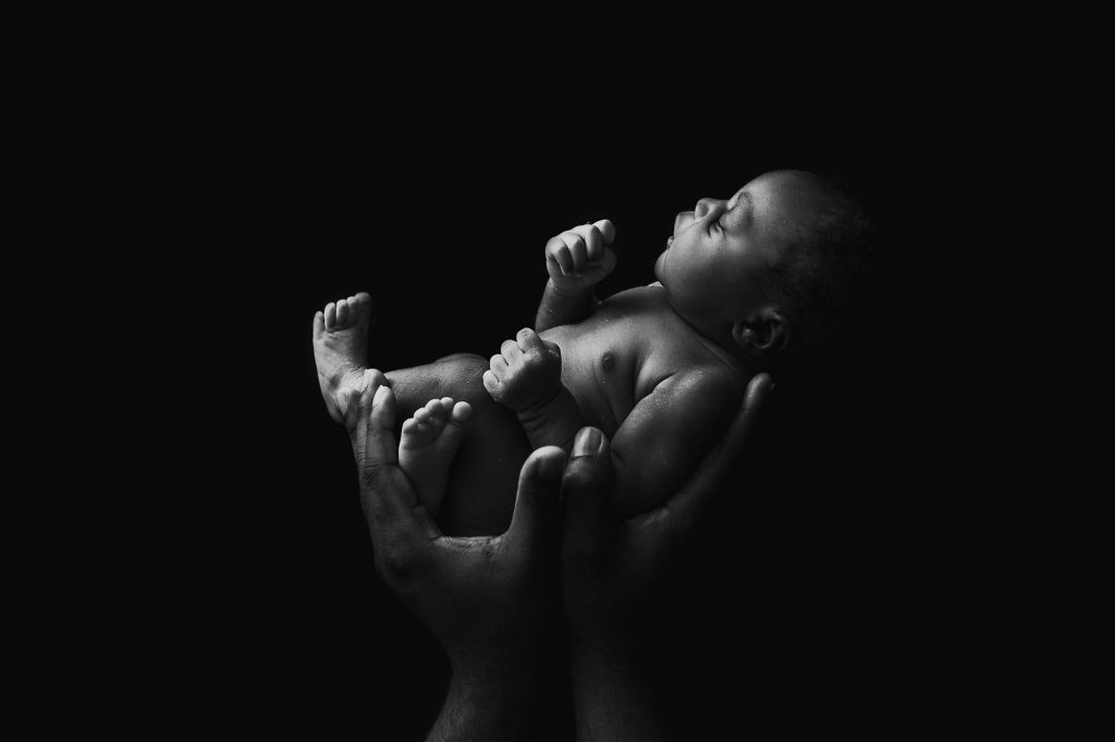 newborn baby girl in dads hands