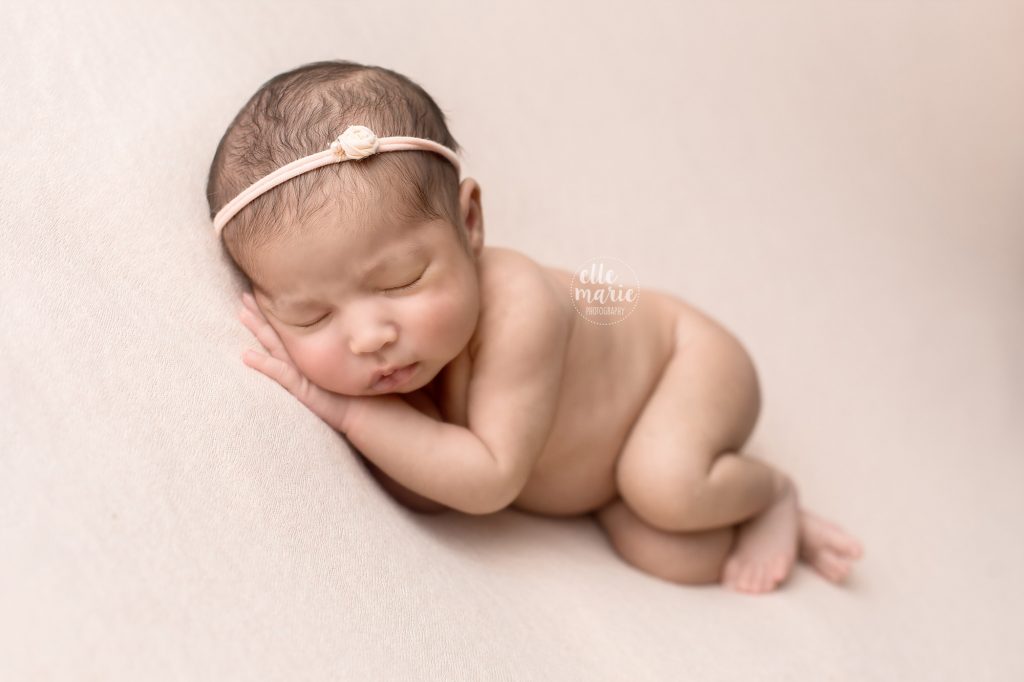 newborn baby girl laying on her side