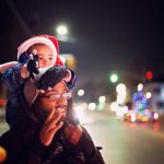 son on dad's shoulders watching Christmas Parade