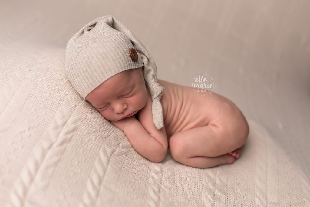 newborn baby boy wearing sleepy cap