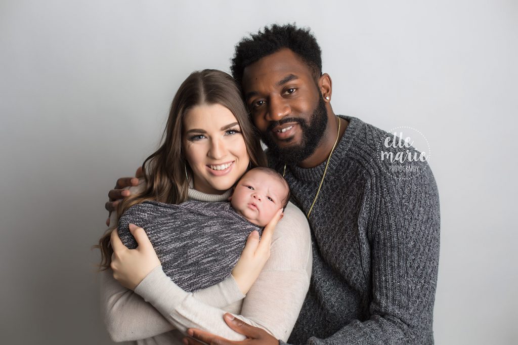 family of 3 with newborn posing