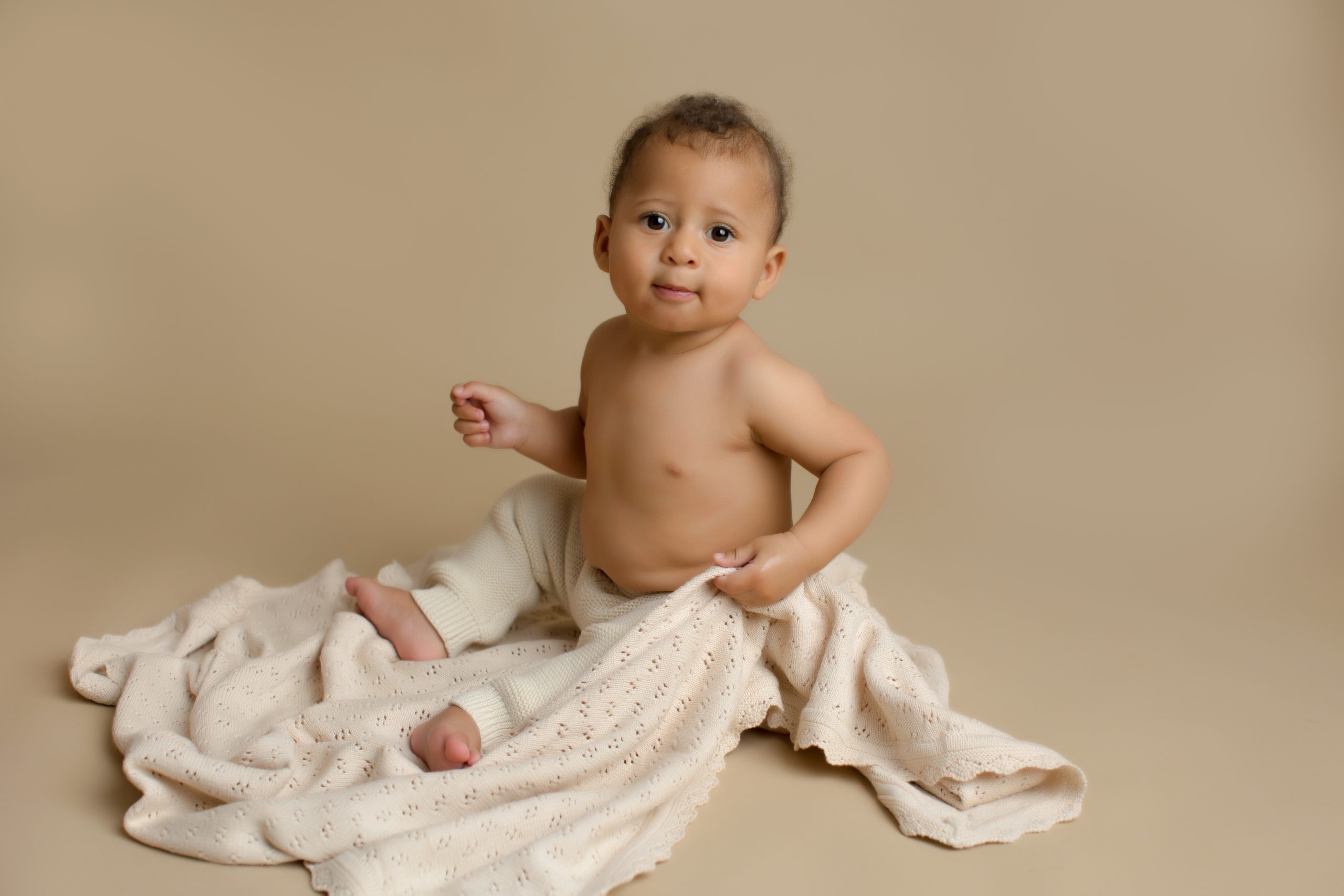 6 month old baby buy on brown backdrop