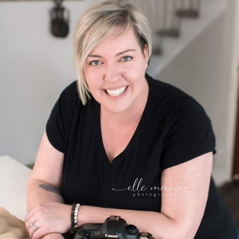Lyndsey Thomas sitting in her home with her camera on the counter