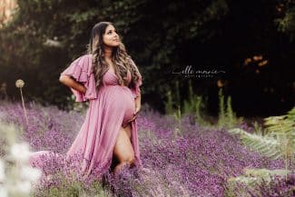 pregnant mom standing in field of lavender
