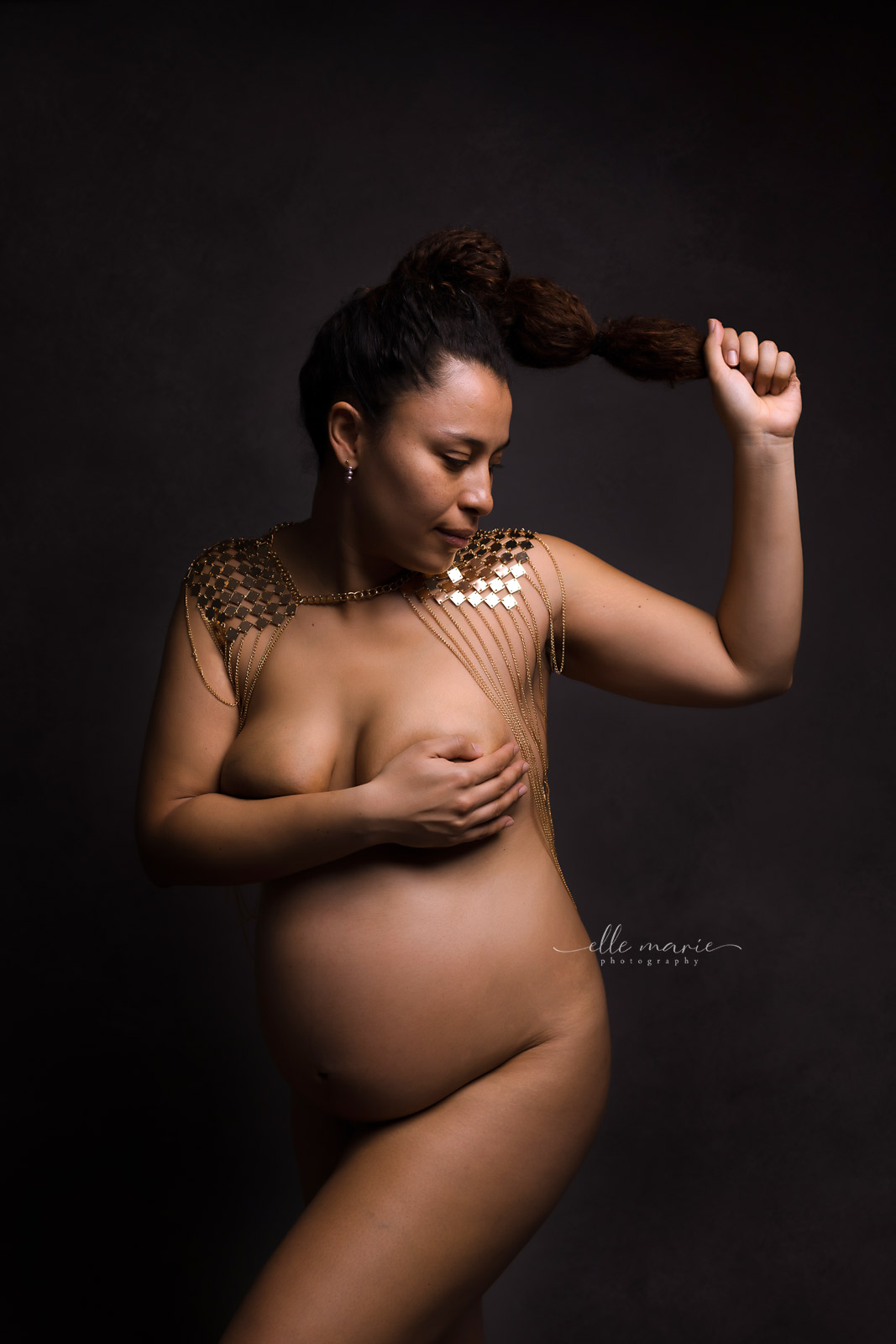 a pregnant woman posing nude