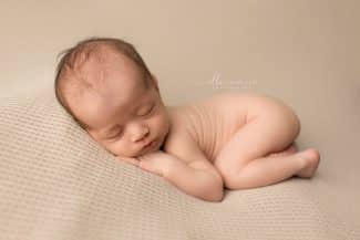 newborn baby curled up