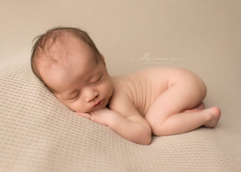 newborn baby curled up