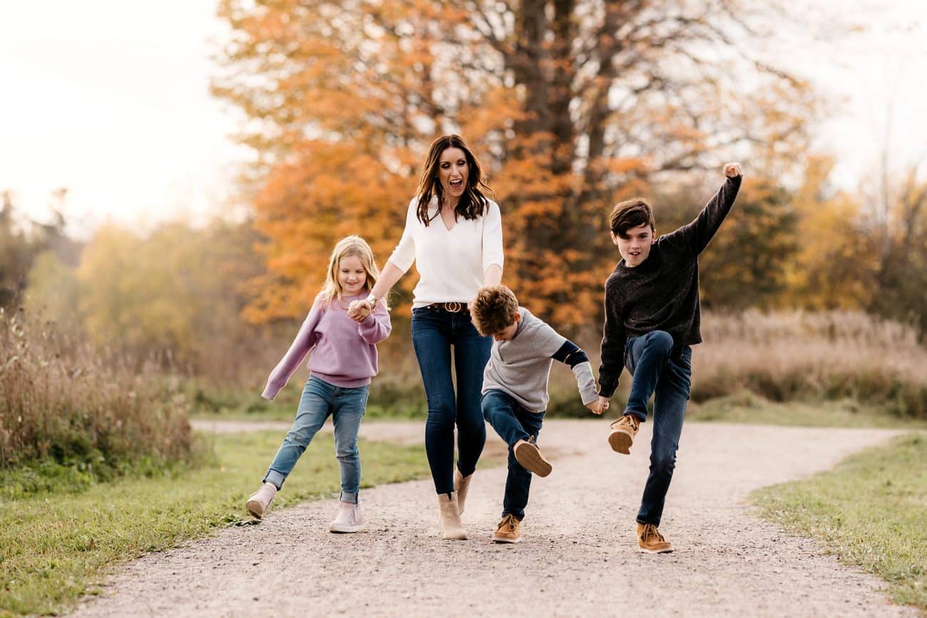 family being silly while walking down a path in whitby