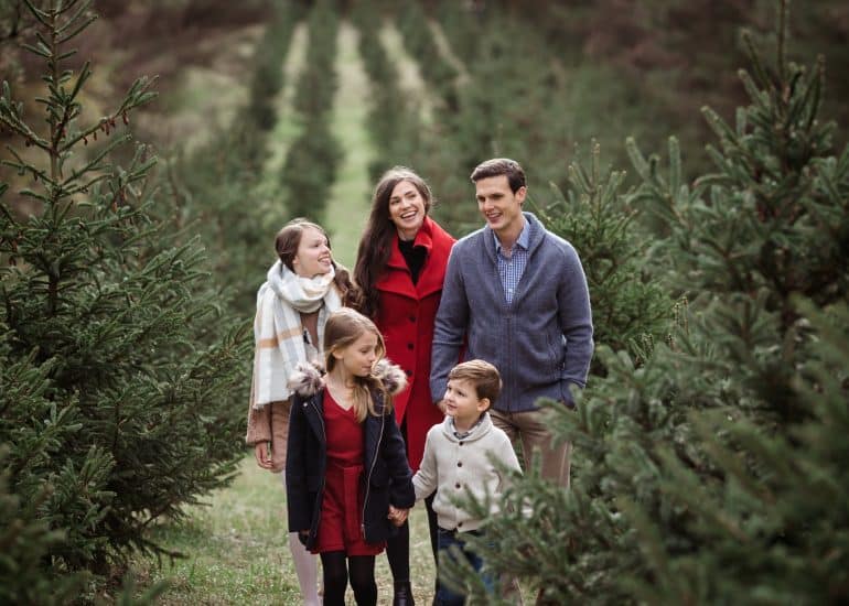 Family of 5 walks through Christmas Tree Farm