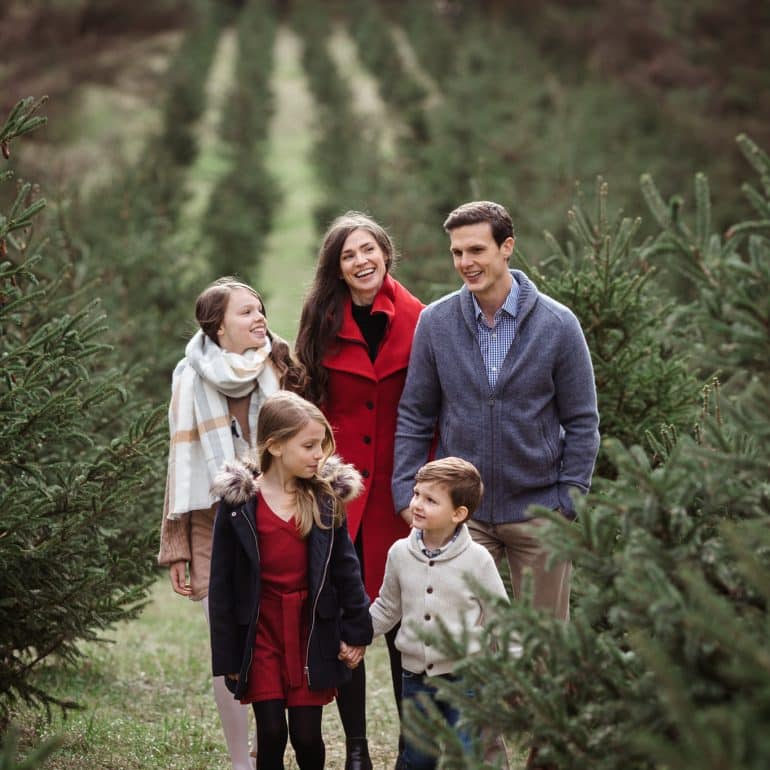 Family of 5 walks through Christmas Tree Farm